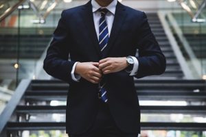 Man in a suit, standing next to stairs